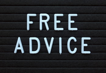 The words Free Advice in white plastic letters on a black letter board