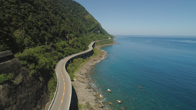 Aerial view of Patapat viaduct in the coast of Pagudpud, Ilocos Norte. Highway with bridge by coast sea near the mountains. Philippines, Luzon. Highway along the coast.