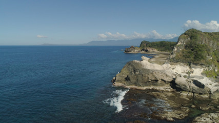 Natural rock formation of limestone stone on the coast. Aerial view of tourist attraction Kapurpurawan Rock Formation in Ilocos Norte Philippines,Luzon.
