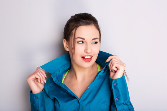 Close Up Confident Young Woman Holding Shirt Collar And Looking Away