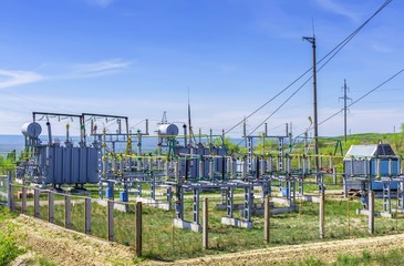 electric transformer station in the open air, transformers, wires, electrical equipment against the...
