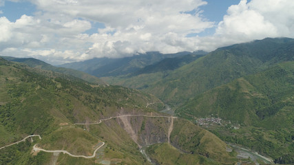 Naklejka premium Aerial view of mountain river in the cordillera gorge, mountains covered forest, trees. Cordillera region. Luzon, Philippines. Mountain landscape.