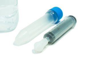 Syringe and saline for washes nose on isolated white background.