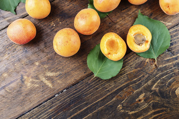 ripe apricots on a wooden background