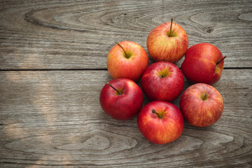 Red apples on a wooden table background