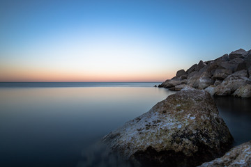 Rocks in the sea at blue hour. 