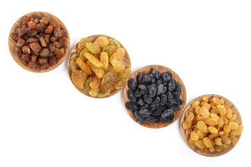 Collection of raisins in wooden bowl isolated on a white background with copy space for your text. Top view. Flat lay