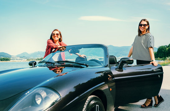 Two female freinds traveling by cabriolet
