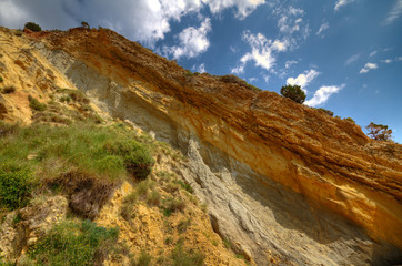 Obraz premium Soil profile in a cliff, showing terra rossa, reddish soil, heavy and clay-rich, developed on a limestone base