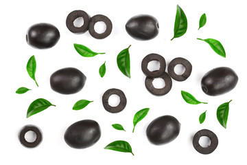 whole and sliced black olives decorated with leaves isolated on white background. Top view. Flat lay pattern
