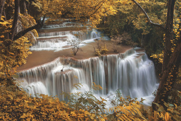 Waterfall with yellow foliage