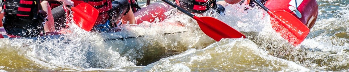 Rafting, kayaking. Extreme sport. Water ecological tourism. Close-up view of oars with splashing...