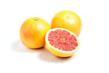 Ripe round grapefruits and red half on white isolated background