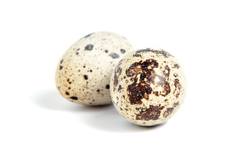 Two Quail spotted eggs, isolated on a white background