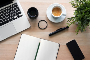 Top view of office work desk with laptop and diary on white background