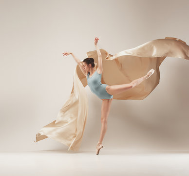 Modern ballet dancer dancing in full body on white studio background.