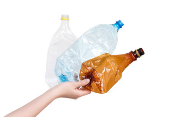 Female hand holding different types of crushed plastic bottles isolated on white. Recyclable waste. Recycling, reuse, garbage disposal, resources, environment and ecology concept