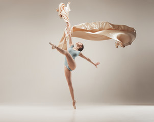 Modern ballet dancer dancing in full body on white studio background.
