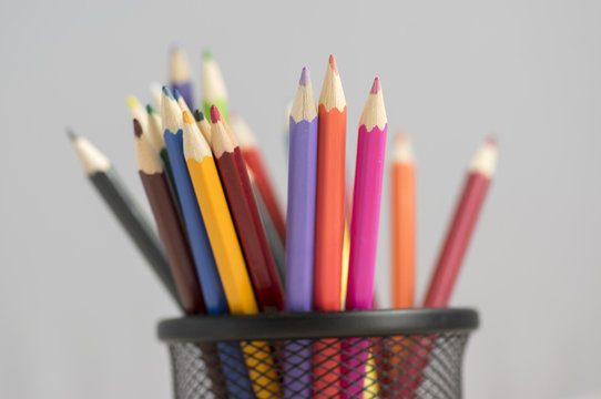 Close up of wooden colorful pencils, group of scattered crayons, isolate od white background