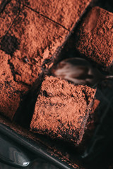 Decadent moist dark chocolate stout beer brownies cut in squares. Dark food photography concept