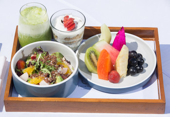 Healthy breakfast with fruits, salad, juice on tray