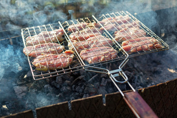 Barbecue meat on the grill, cooking meat outdoors, summer activity