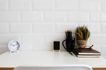 White desk table with copy space, supplies and coffee mug. Front view workspace and copy space