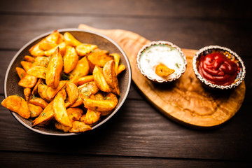 Baked potato fries on wooden table