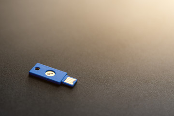 Security system concept. Key-shaped USB drive on dark background. Technology and data security theme.