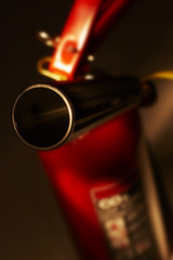 CLOSE UP OF RED CARBON DIOXIDE FIRE EXTINGUISHER SHOWING NOZZLE