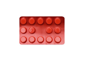 Tablets in red blister package, on white background.