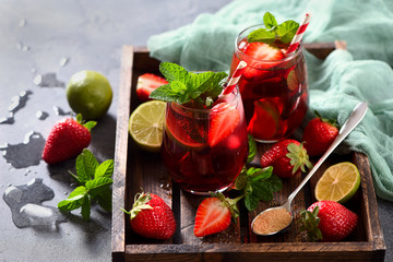 Strawberry lemonade drink, refreshing summer sangria with strawberries, lime and mint