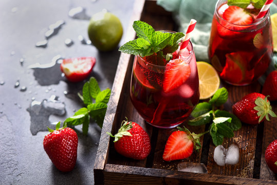 Strawberry lemonade drink, refreshing summer sangria with strawberries, lime and mint