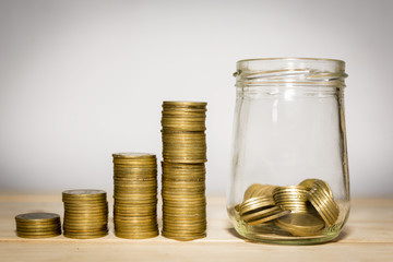 money in the glass and Coin  stacks on a white background