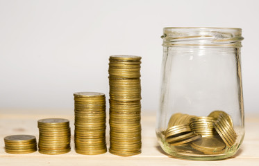 money in the glass and Coin  stacks on a white background