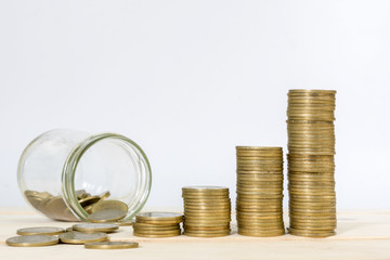 money in the glass and Coin  stacks on a white background