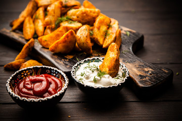 Baked potato fries on wooden table
