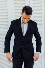 Portrait of handsome man in black suit