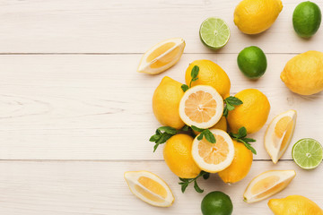 Heap of lemons on rustic wooden background, top view