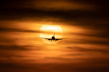 Fototapeta na wymiar Beautiful sunset with sun behind airplane
