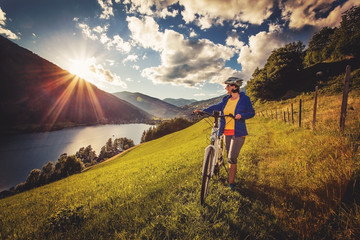 woman on e-bike enjoying view to a beautiful lake