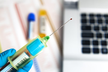 hand of a lab technician with blood collection needle / hand of a laboratory technician holding a tube adapter with needle for collection of blood samples