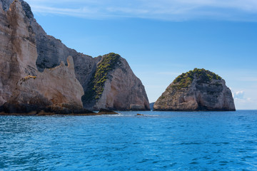 Naklejka premium Blue Caves and blue water of Ionian sea on Island Zakynthos in Greece and sightseeing points. Rocks in clear blue sea
