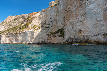 Fototapeta na wymiar Blue Caves and blue water of Ionian sea on Island Zakynthos in Greece and sightseeing points. Rocks in clear blue sea