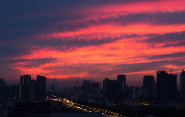 colorful romantic sunset twilight sky in the bustling city background