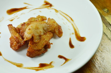 deep fried chicken dressing tomato sauce on white plate