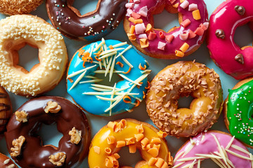 Group of donuts on blue background, from above