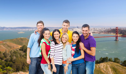 travel, tourism and people concept - group of happy friends over golden gate bridge in san francisco bay background