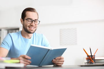 Student studying at table indoors