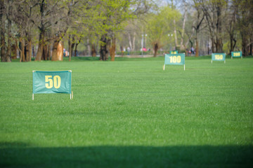 A fragment golf course in the pine forest. Marks distances.
